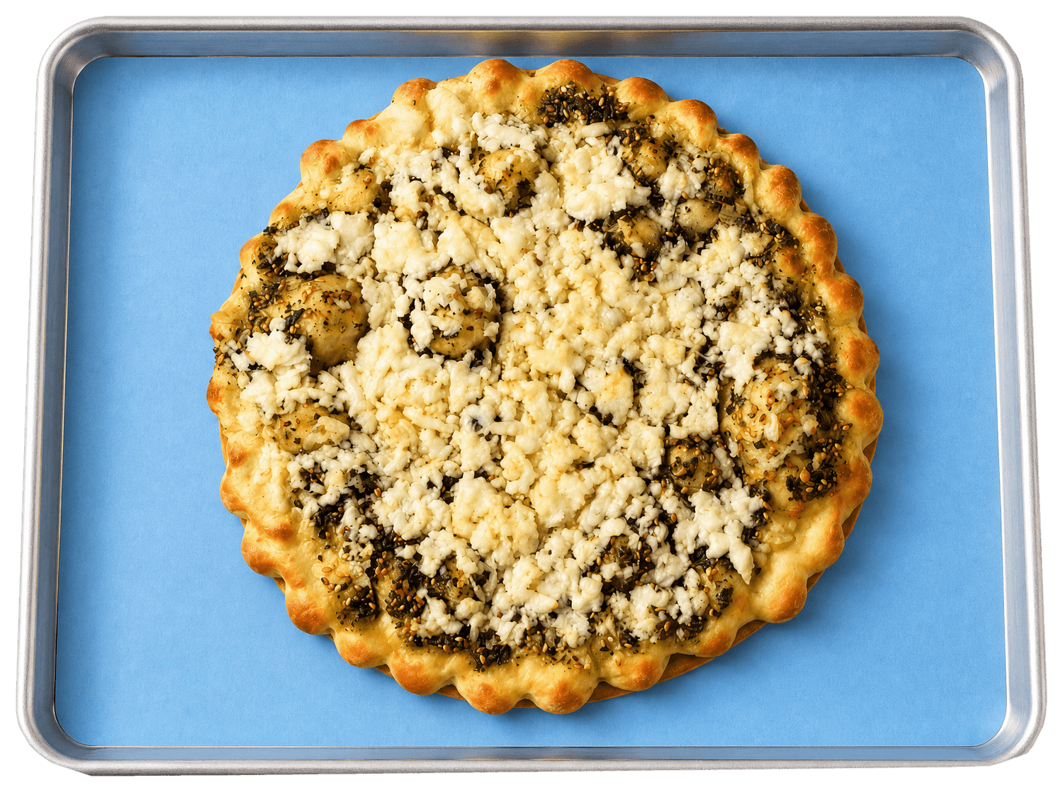 A za'atar and cheese manousheh on a Crave baking tray lined with blue paper, seen from above.